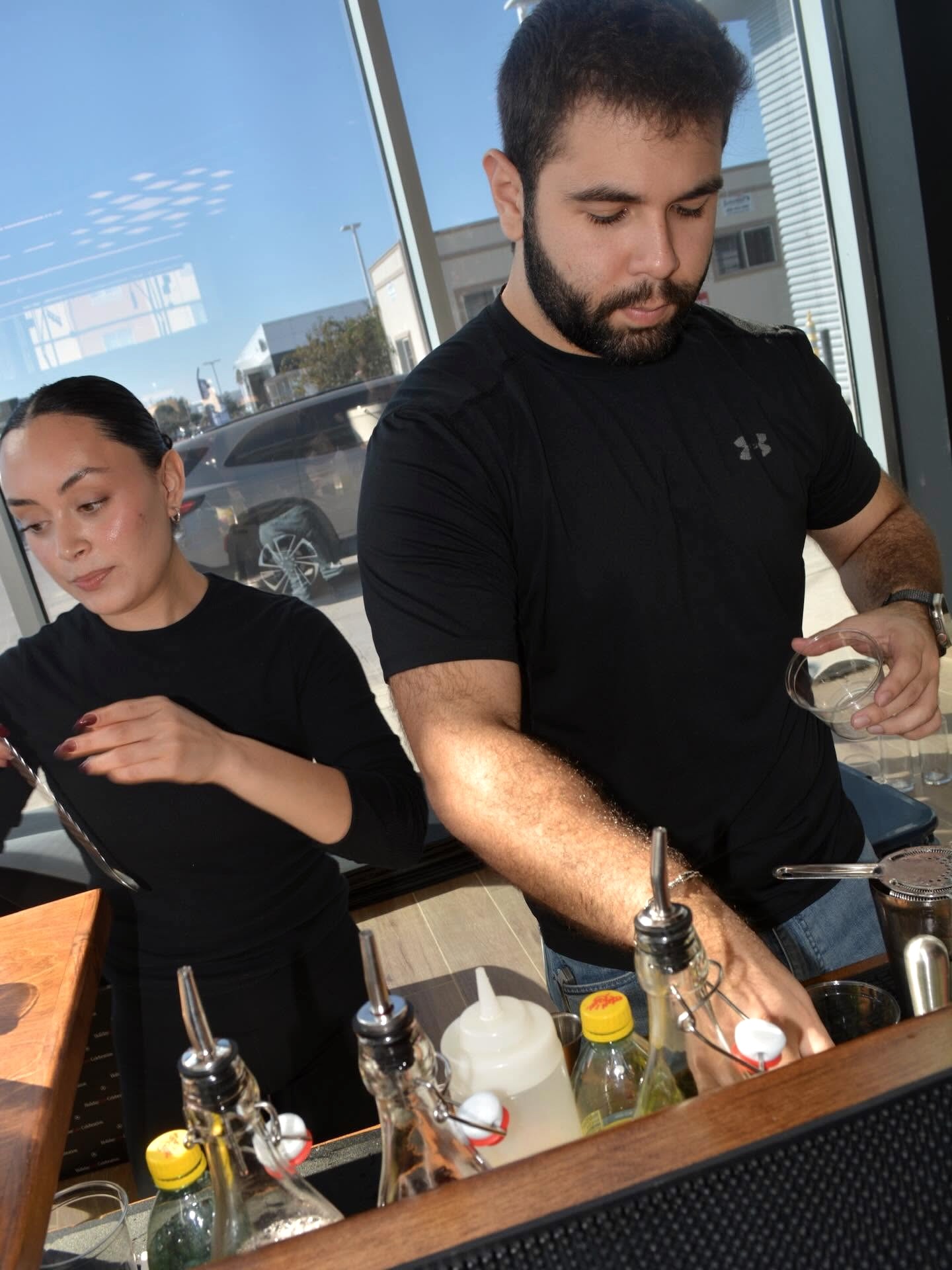 La Mezcla bartenders serving guests at the Mercedes-Benz event