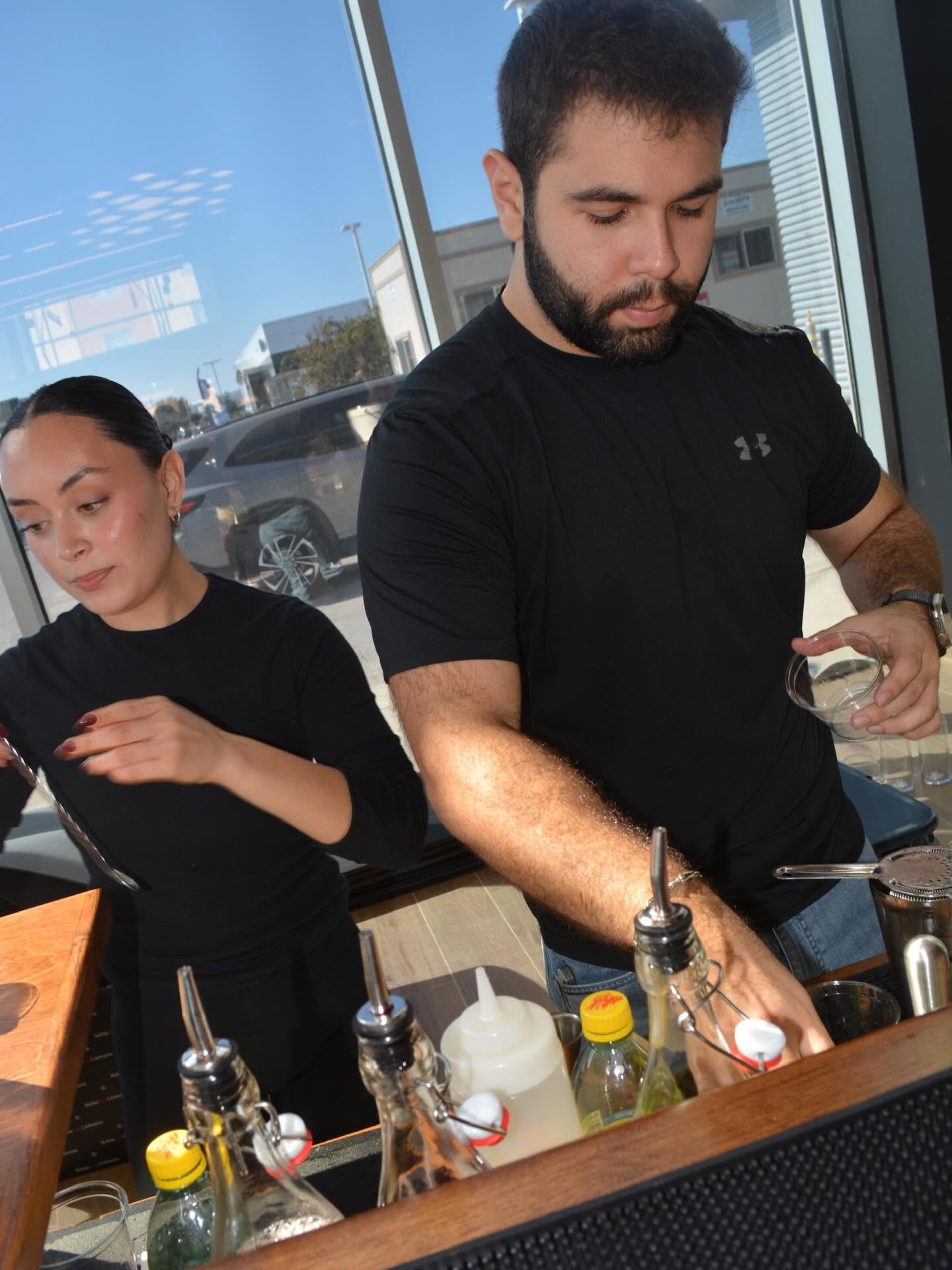 La Mezcla bartenders serving guests at the Mercedes-Benz event