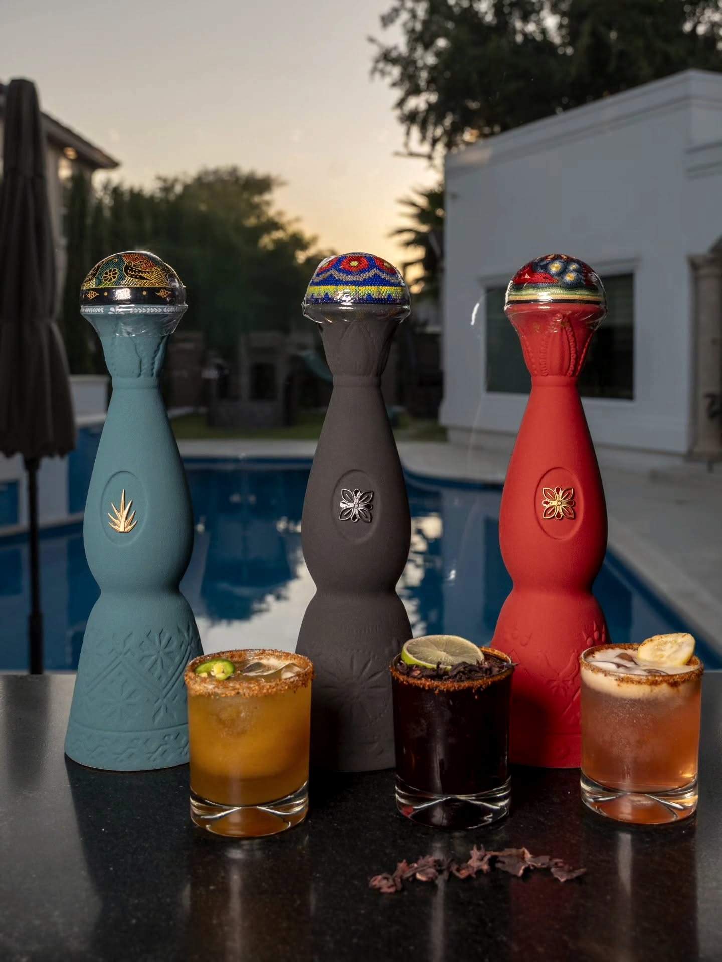 Premium tequila bottles and margaritas at the La Mezcla poolside bar at sunset
