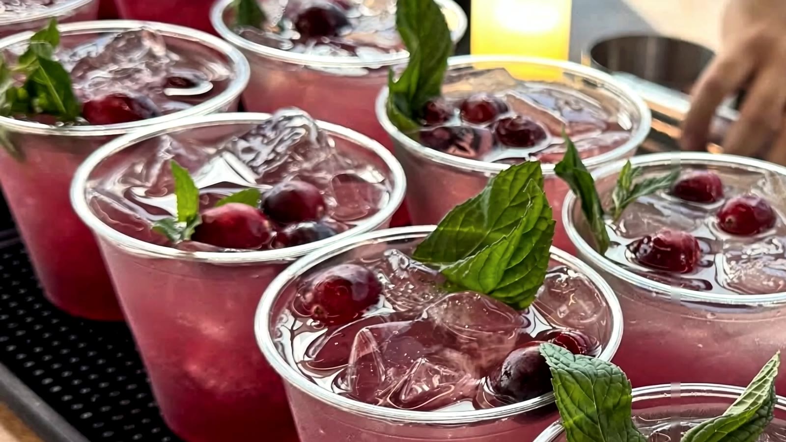 La Mezcla cranberry cocktails garnished with mint and fresh cranberries.