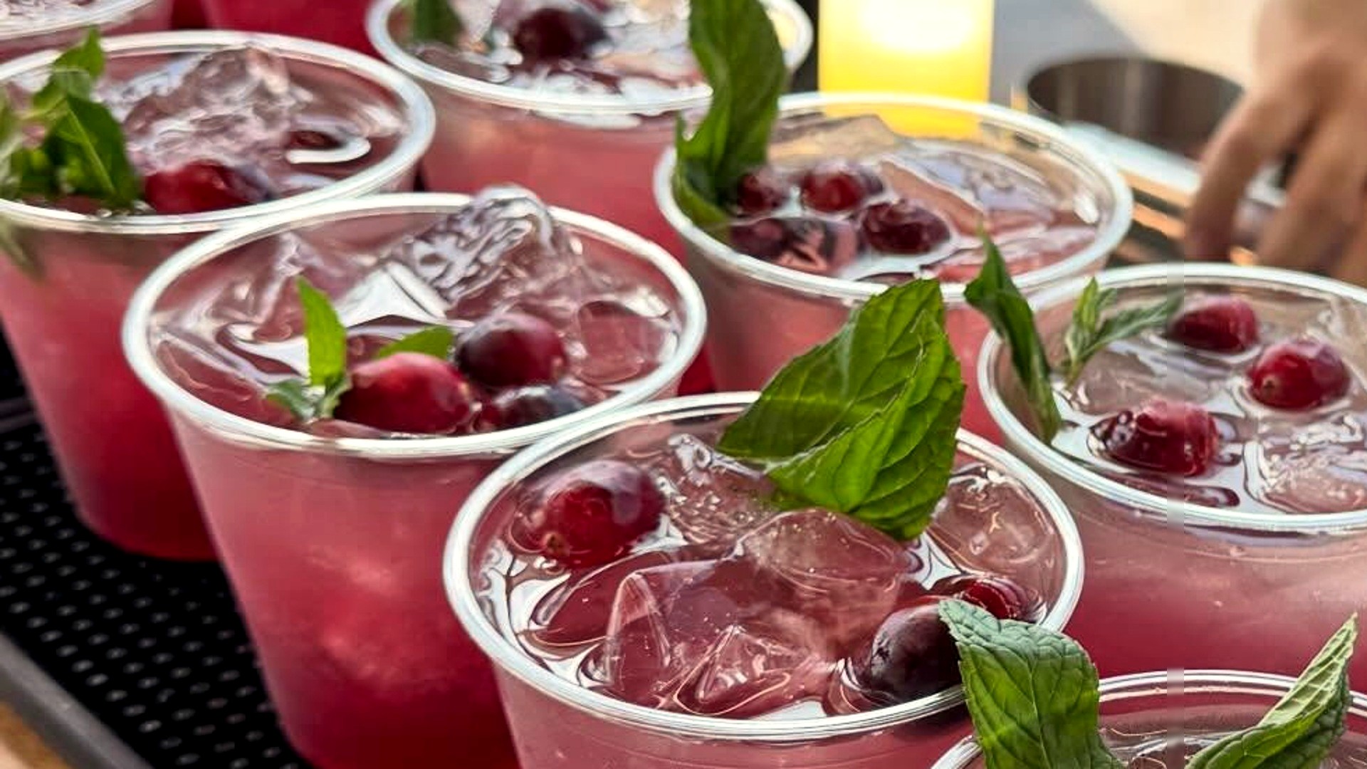La Mezcla cranberry cocktails garnished with mint and fresh cranberries.